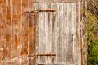 USA, New Hampshire, Troy. Old barn door with rusted strap hinge. Art Print